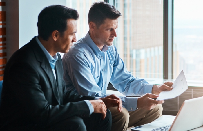 two men looking over documents